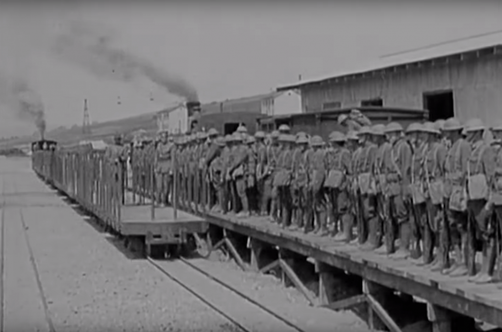 Troops are transferred from broad gauge to the 60cm narrow gauge light railway. Notice the warehouses and larger broad gauge train behind the soldiers.